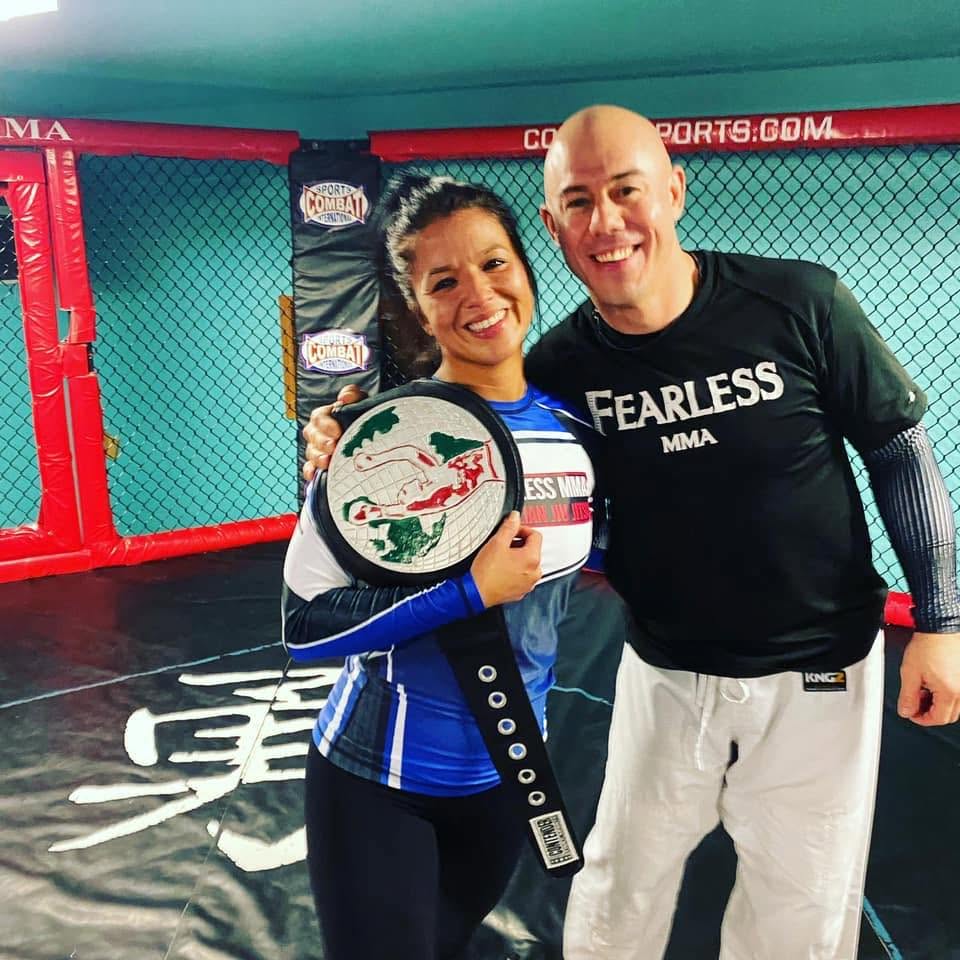 Fearless MMA coach with a champion belt